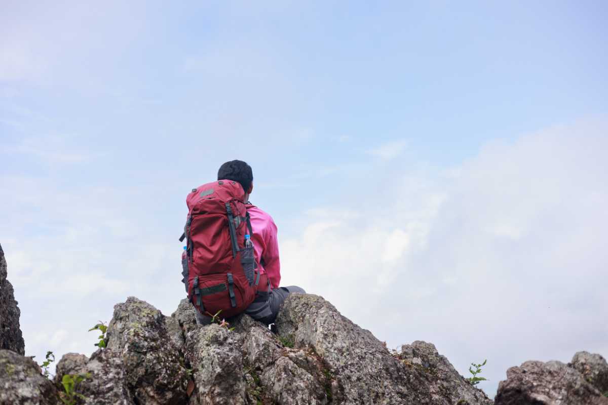Escursionisti in cima al Monte Epomeo con vista su Procida e il Golfo di Napoli, luce dorata al tramonto, atmosfera di conquista e natura selvaggia